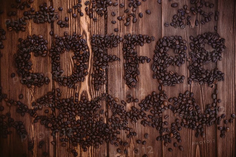 Roasted coffee beans close-up on a wooden surface
