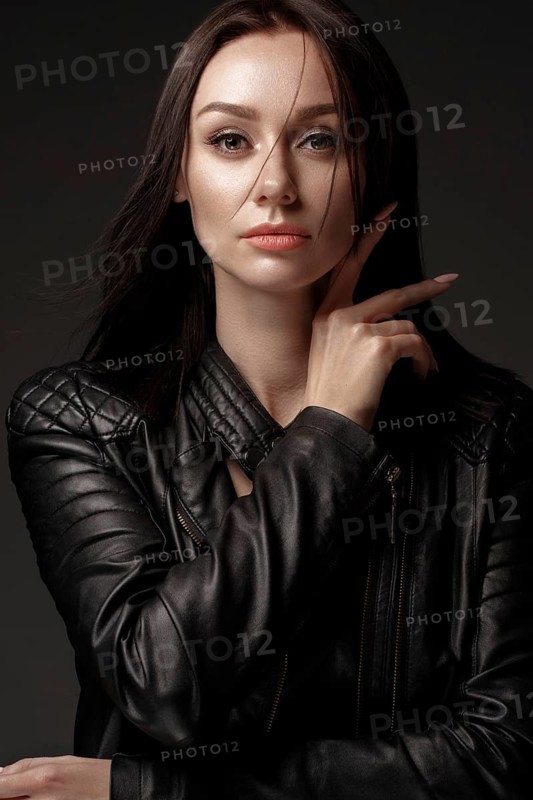 Daring girl model in black leather dress