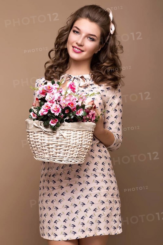 Fresh young girl in a light silk dress