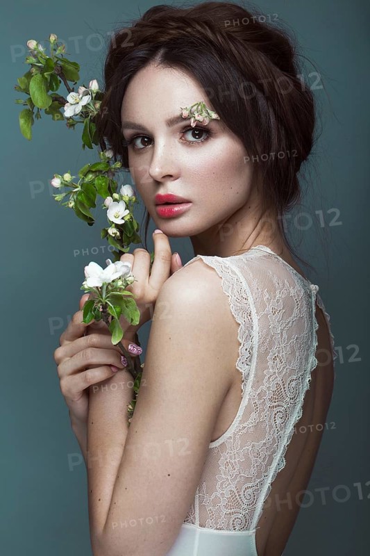 Beautiful brunette girl in lingerie with a gentle romantic make-up