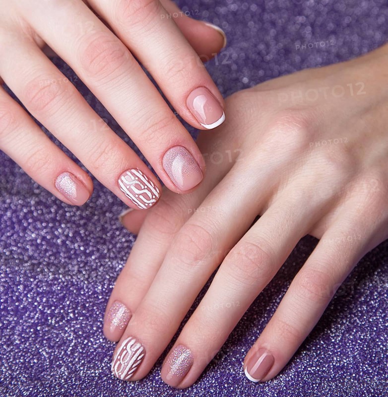Snow White manicure on female hands. Winter nail design. Picture taken in the studio