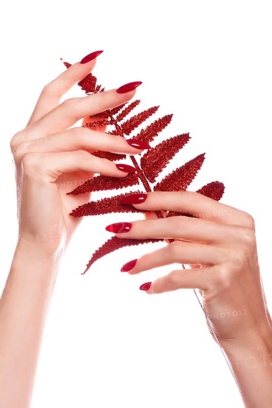 Bright festive red manicure on female hands. Nails design