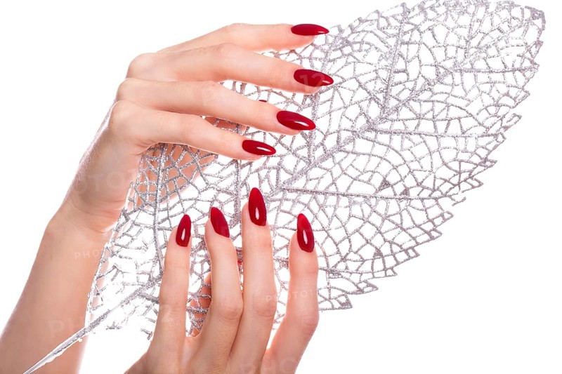 Bright festive red manicure on female hands. Nails design
