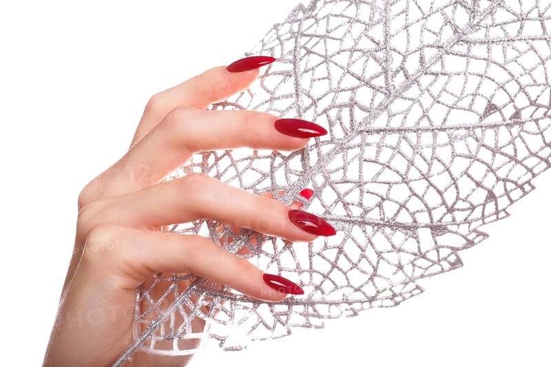 Bright festive red manicure on female hands. Nails design