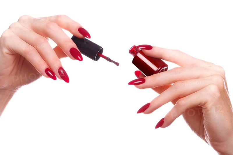 Bright festive red manicure on female hands. Nails design