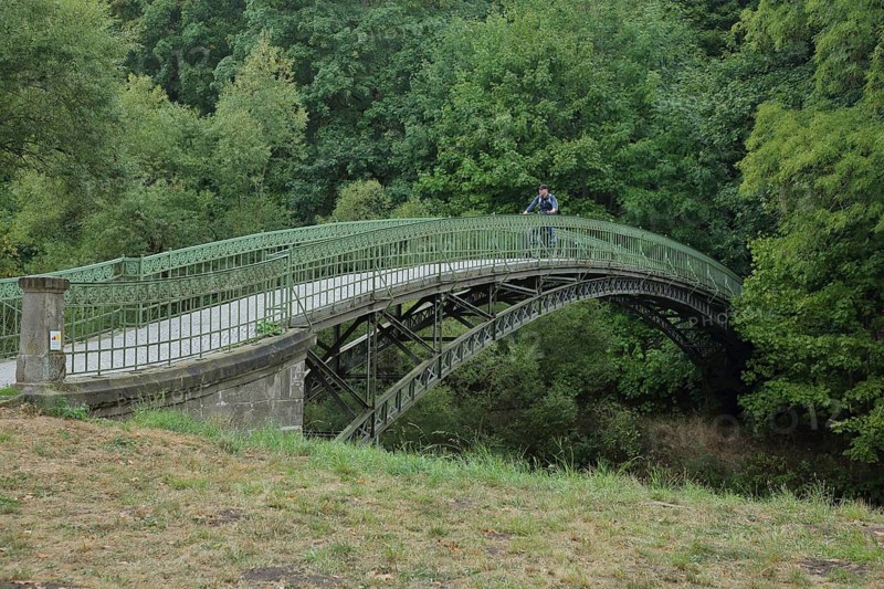 Historic arched bridge with cyclist over the Werra