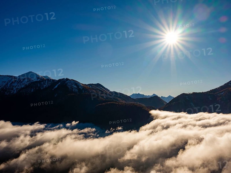 Mountains of the Salzkammergut and Tennengebirge above the sea of clouds in sunshine