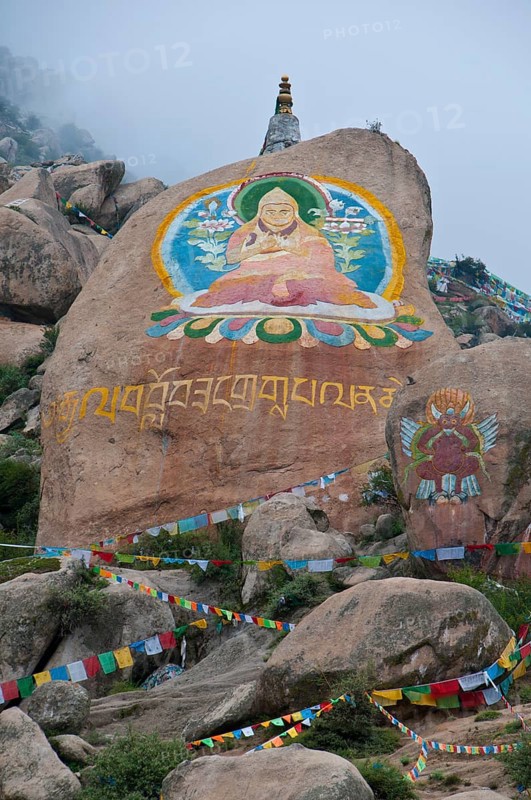 Huge Buddha painted on a rock behind the Drepung temple