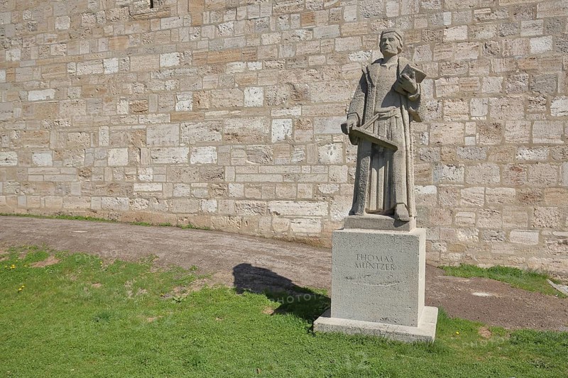 Monument and statue by Thomas Muenzter with book