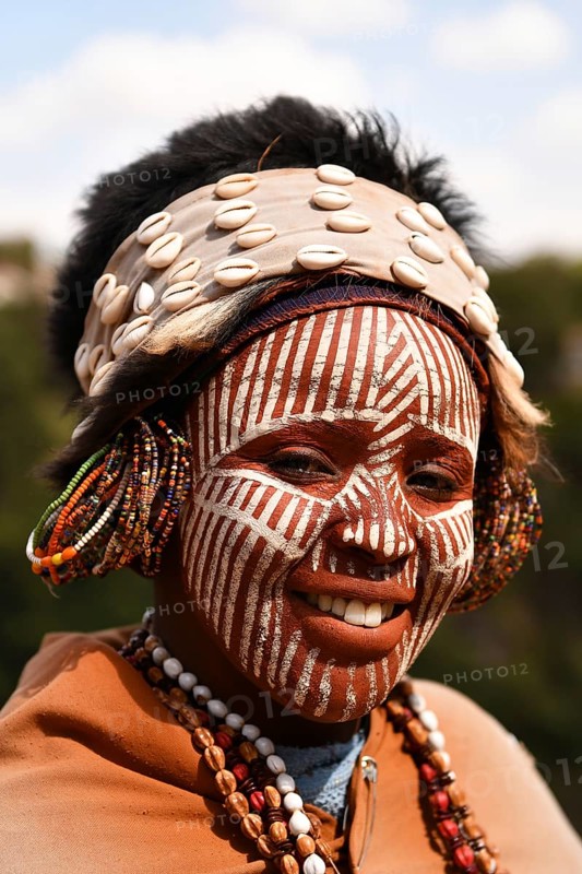 Kikuyu woman with face paint poses for photographers at Nyahururu Falls