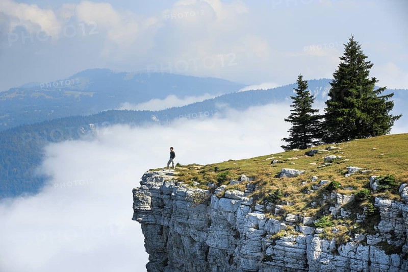 Man standing on the edge of the Creux du Van