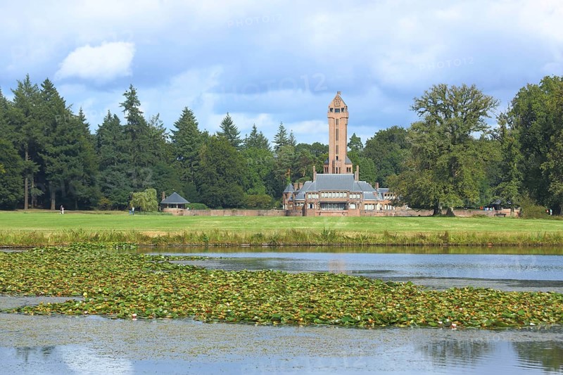 View of Jachthuis Sint Hubertus built 1915 on the lake with pond roses