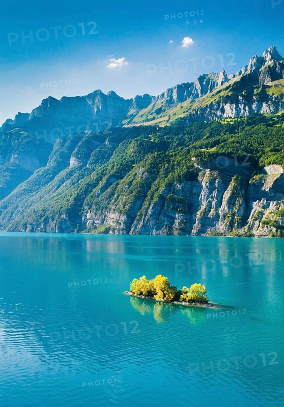 Aerial view of Lake Walen with a view of Chive Island in the turquoise water and Leistchamm and Churfirsten in the background