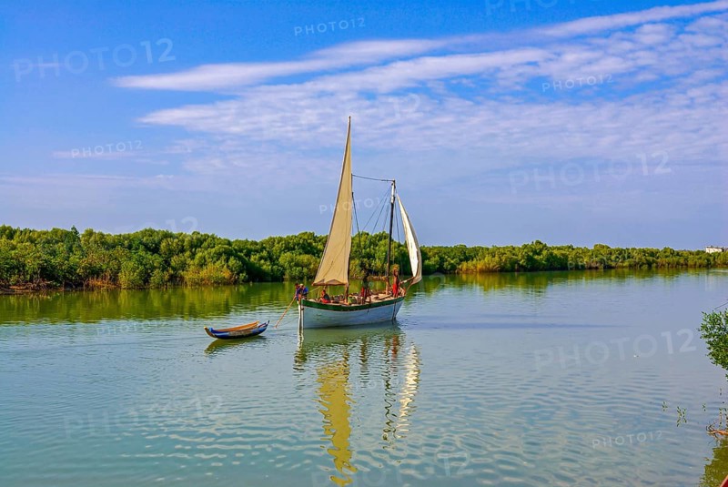 Little sailing boat shipping on a side arm