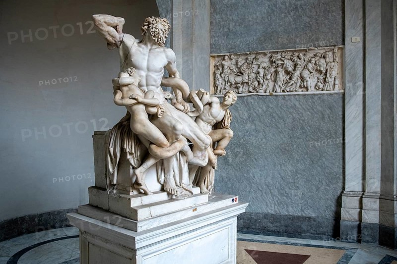View from half left on historical sculpture in marble Marble sculpture by ancient sculptor Laocoon Group of priest Laocoon and sons fighting battle with snake