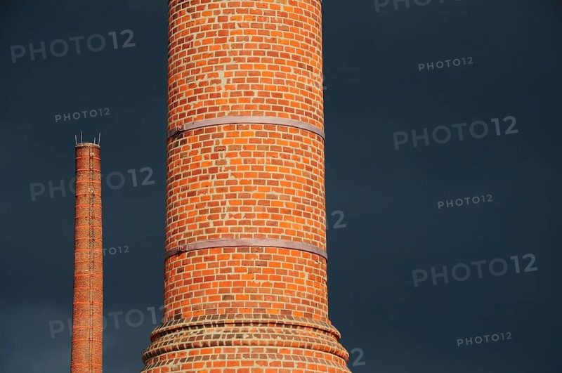 Factory chimney in front of storm clouds
