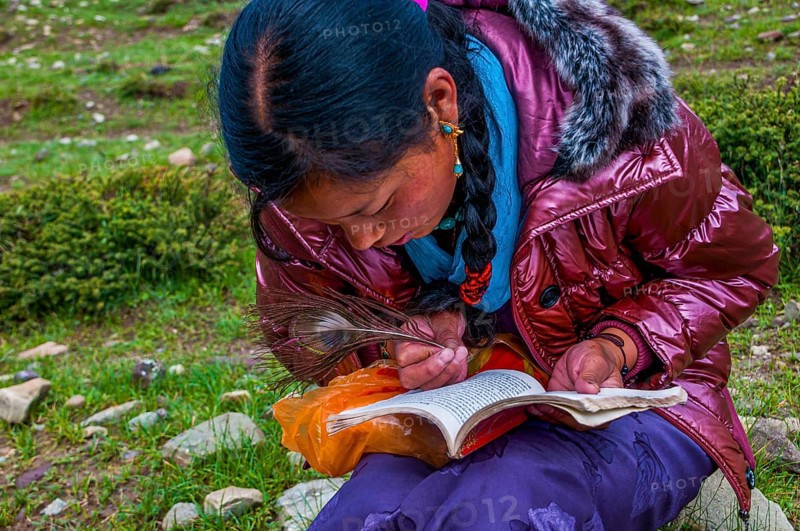 Student writing with a peasant feather