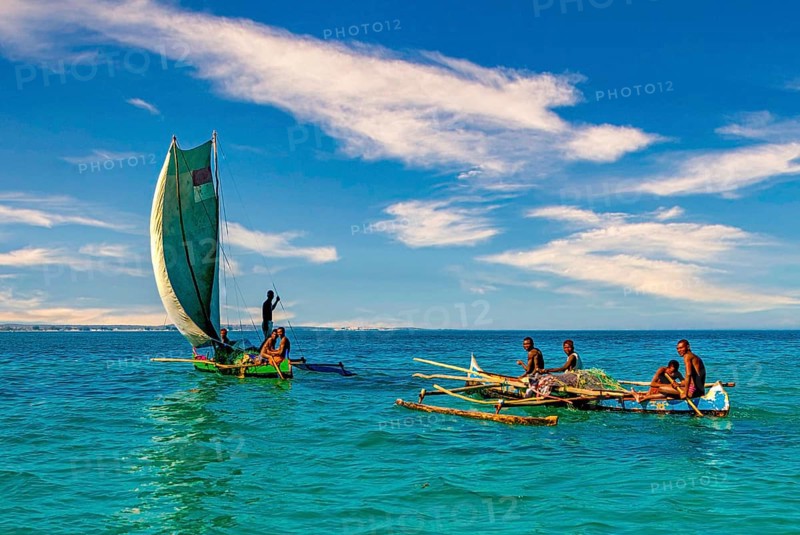 Traditional sailing boat and rowing boat with a dead