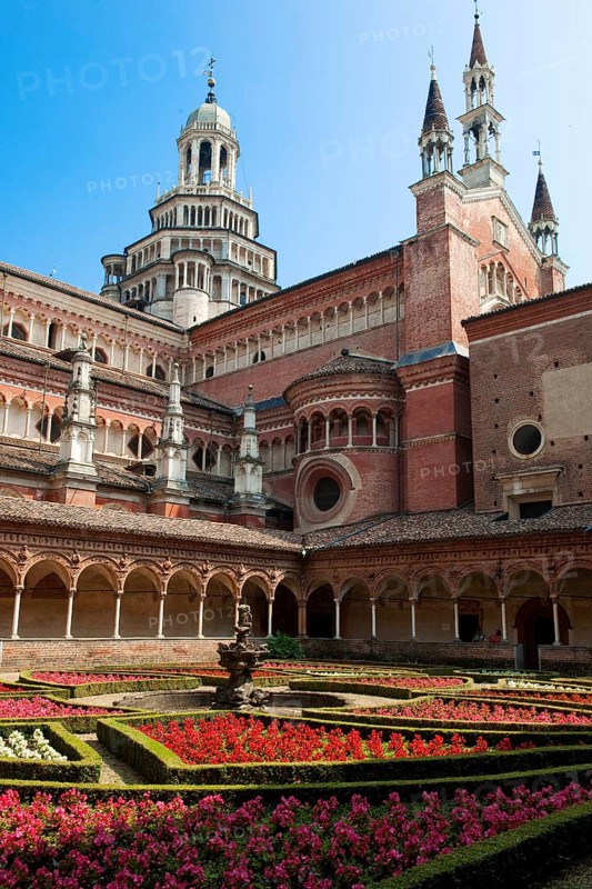 Inner courtyard decorated with planted flowers behind cloister