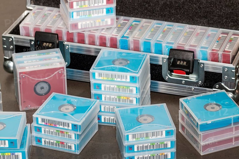 Data backup magnetic tapes lie next to a lockable transport case
