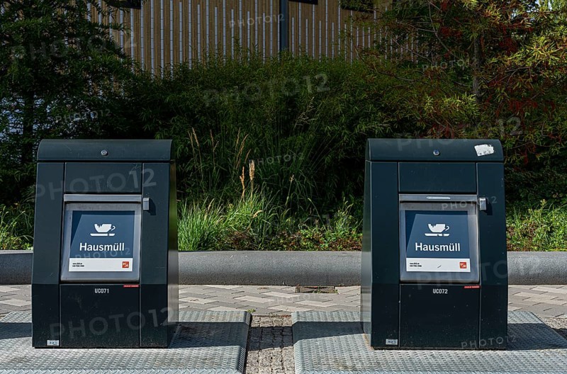 Modern household waste containers in front of new buildings in Europacity