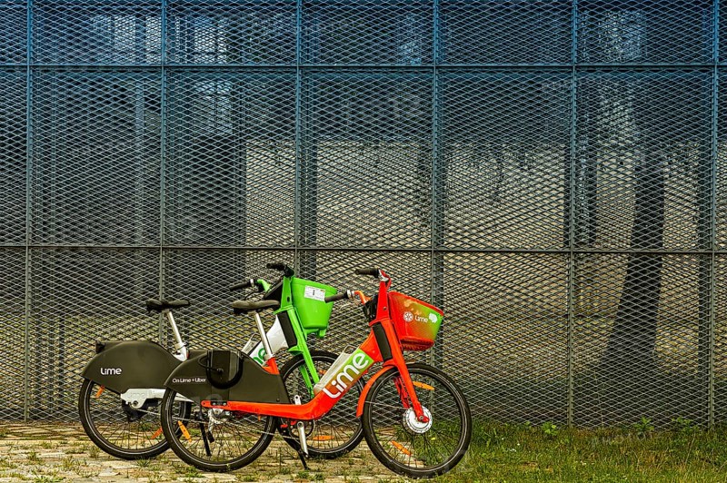 Lime rental bikes in front of high mesh fence