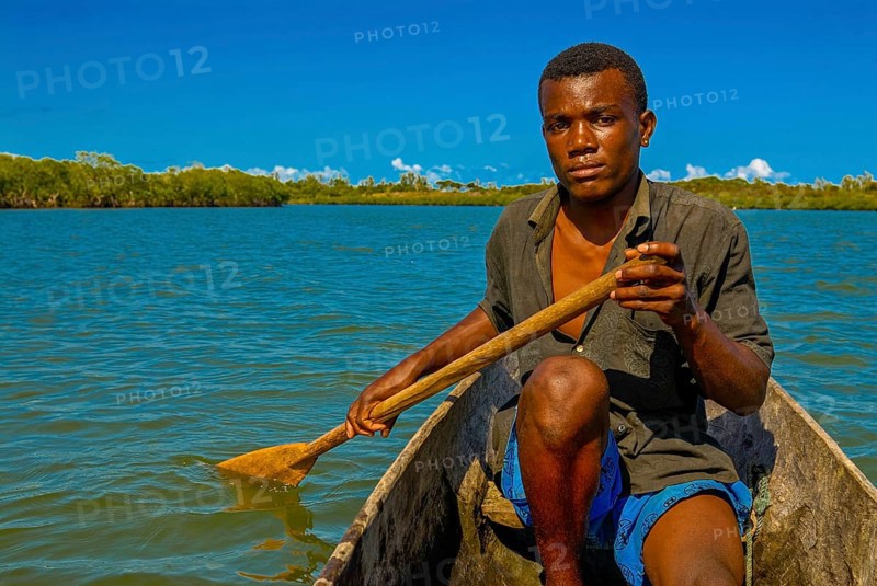 Man paddling through the mangroves of the Island Ile Sainte-Marie although Nosy Boraha