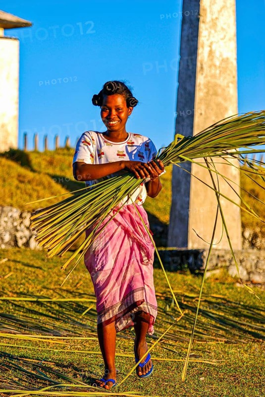 Friendly young woman with red in her hands