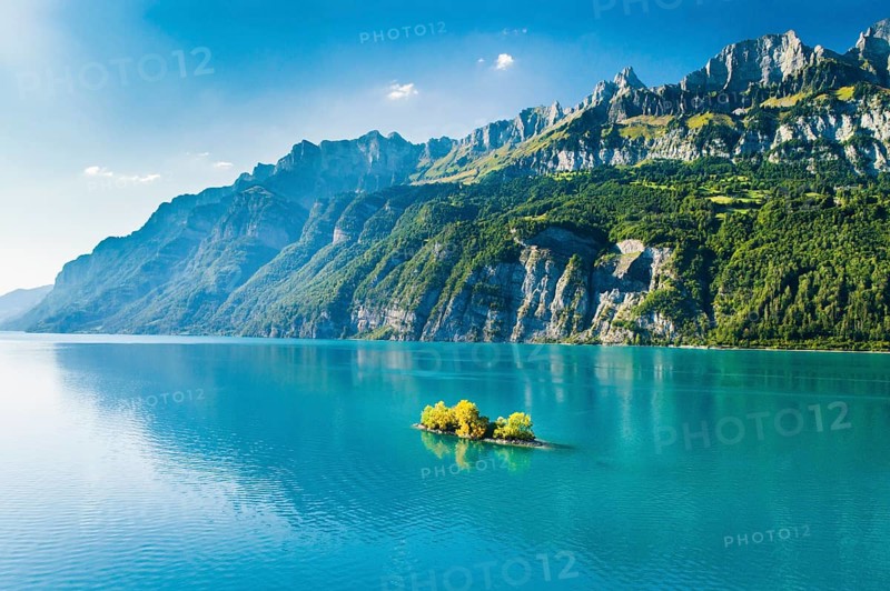 Aerial view of Lake Walen with a view of Chive Island in the turquoise water and Leistchamm and Churfirsten in the background