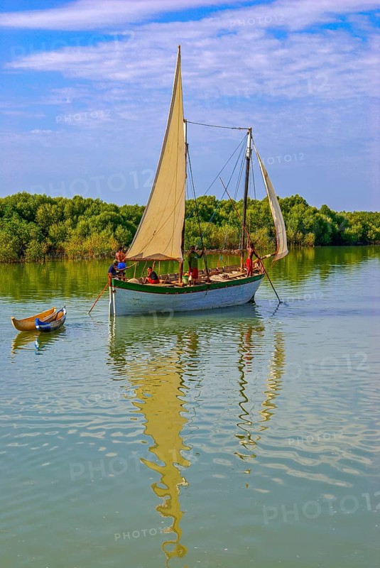 Little sailing boat shipping on a side arm