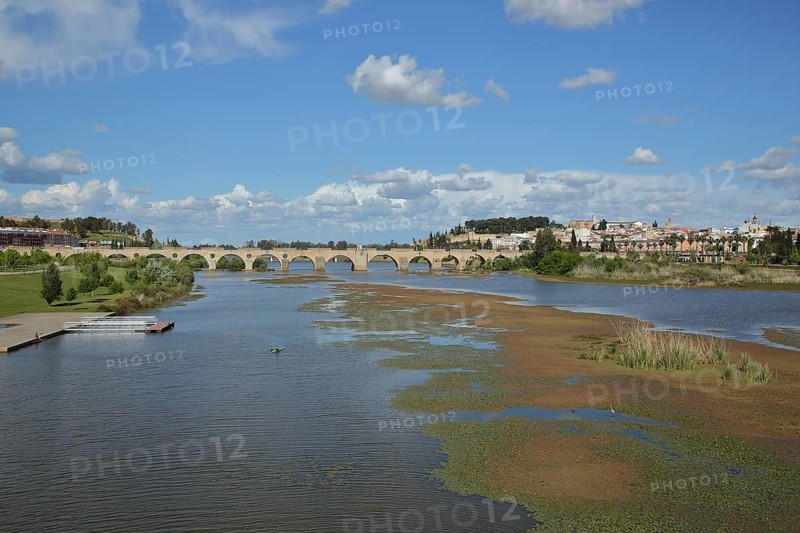 View of the historic stone arch bridge Puente de Palmas built in the 15th century over the river Rio Guadiana