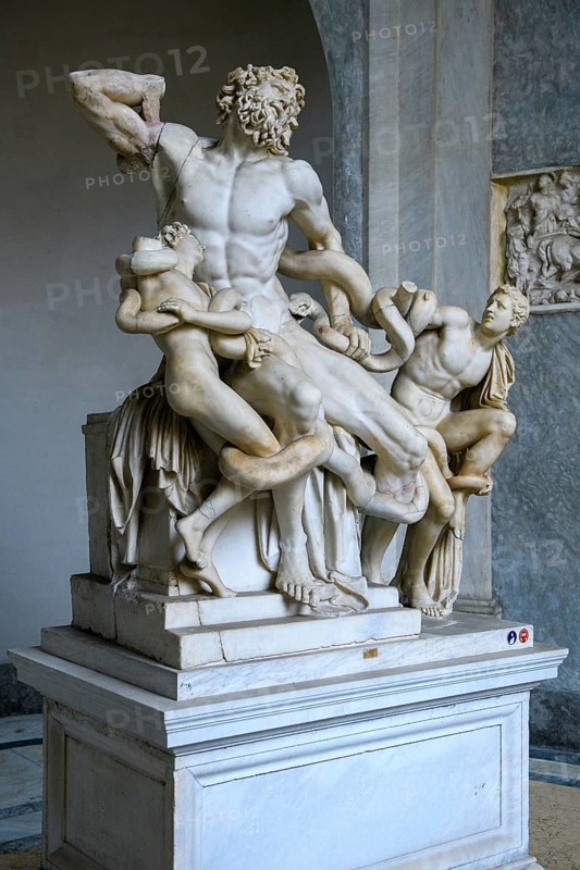 View from half left on historical sculpture in marble Marble sculpture by ancient sculptor Laocoon Group of priest Laocoon and sons fighting battle with snake