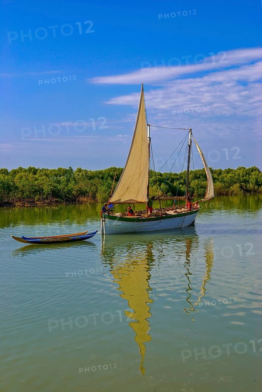 Little sailing boat shipping on a side arm