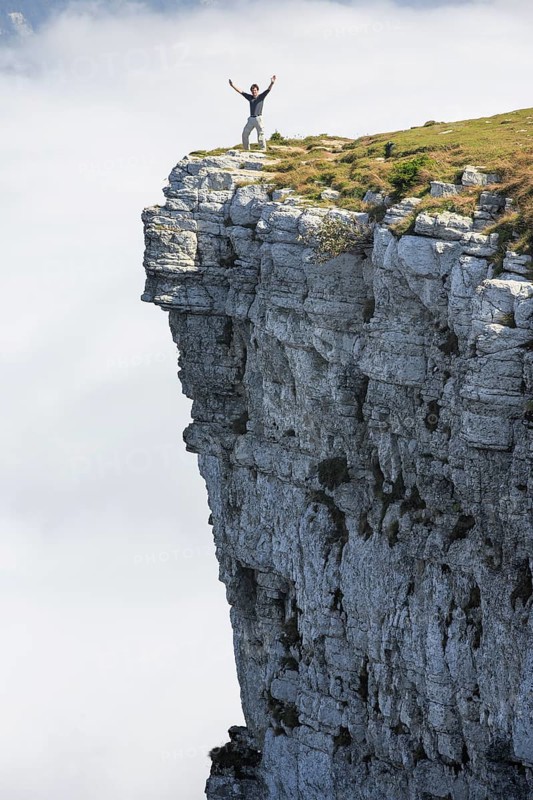 Man standing on the edge of the Creux du Van