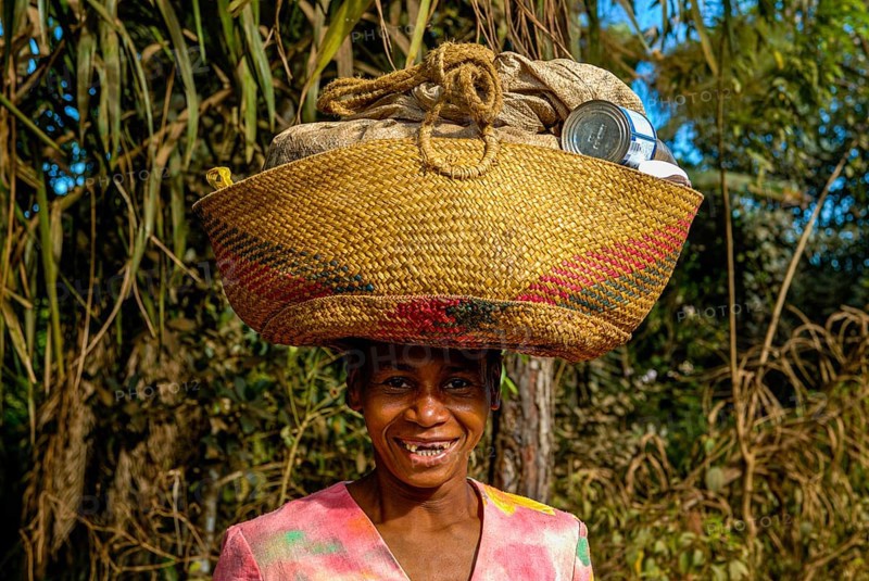 Woman carrying a bag on her head