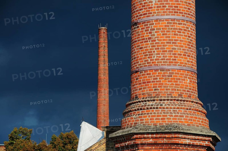 Factory chimney in front of storm clouds
