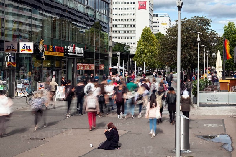 Beggar woman in the pedestrian zone Prager Strasse in the city centre