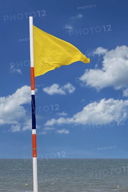 Yellow warning flag signalling medium hazard. Swimming allowed
