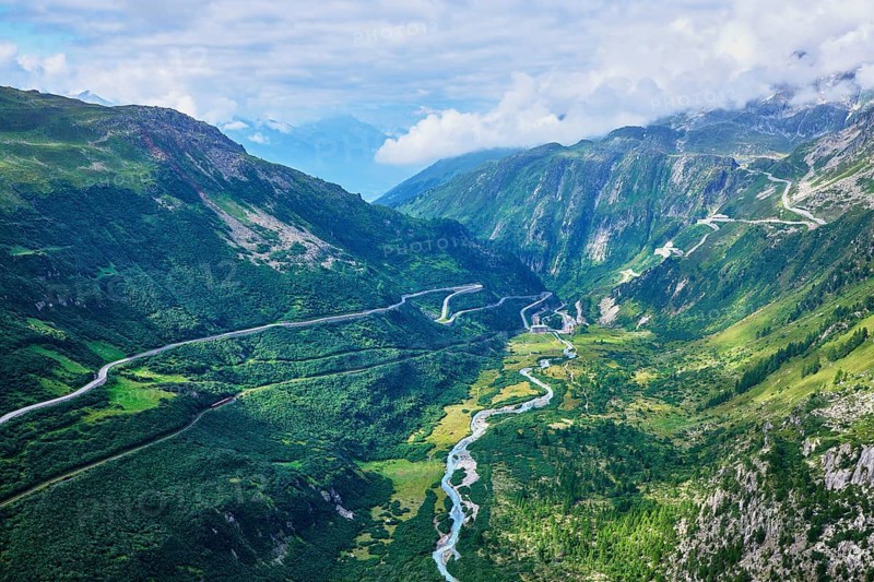 View from the Rhone glacier of the glacial stream and the pass roads