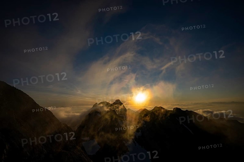 Altmann summit with yellow cloud wisps at sunrise