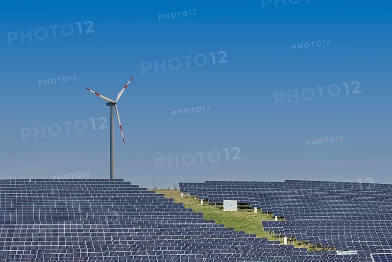 Solar plant with wind turbine in the background