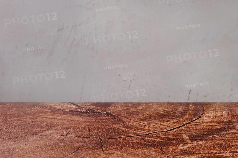 Abstract background with wooden tabletop and grey concrete wall