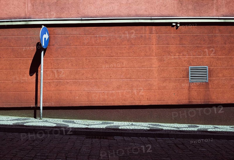 Empty street with blue road sign