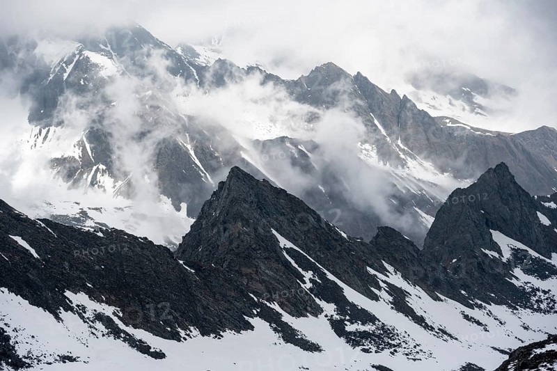Mountains in winter with clouds and fog