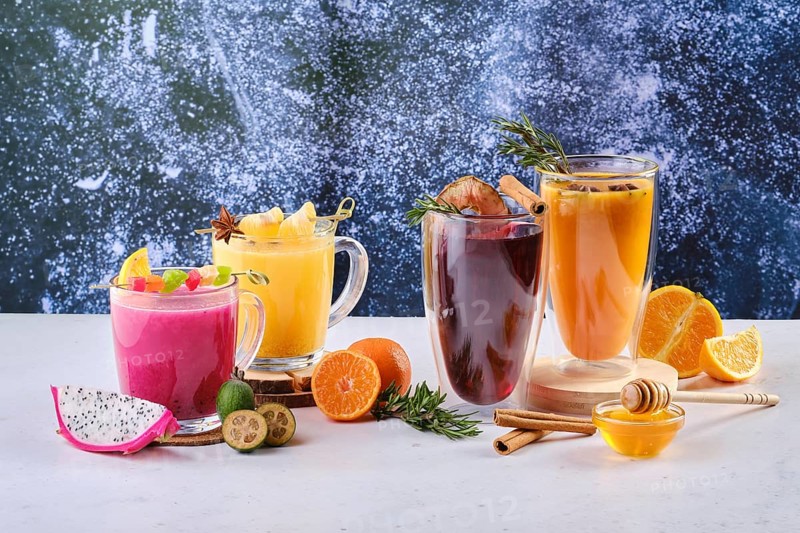Assortment of hot winter drinks with fruits and aromatic herbs