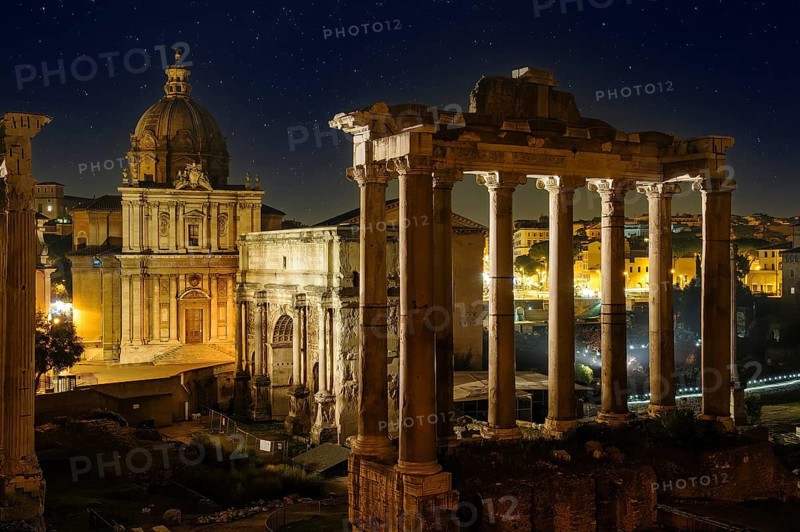 View of right Temple of Saturn of Roman religion centre Arch of Severus on Roman Forum left background Church of Santi Luca e Martina under starry sky night sky with stars