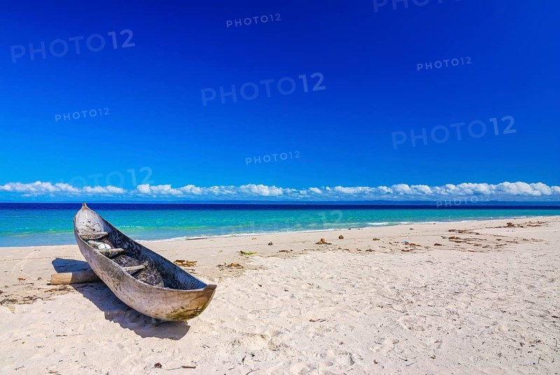Canoe on a white sand beach on the Island Ile Sainte-Marie although Nosy Boraha