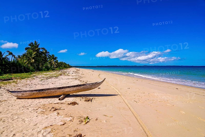 Canoe on a white sand beach on the Island Ile Sainte-Marie although Nosy Boraha