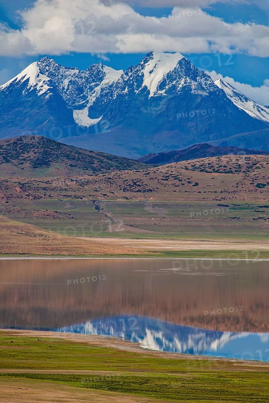 High alpine mountain lake before the Himalaya range along the southern route into Western Tibet