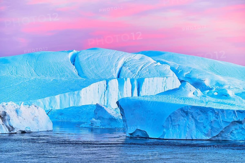 Gigantic icebergs in the light of the blue hour
